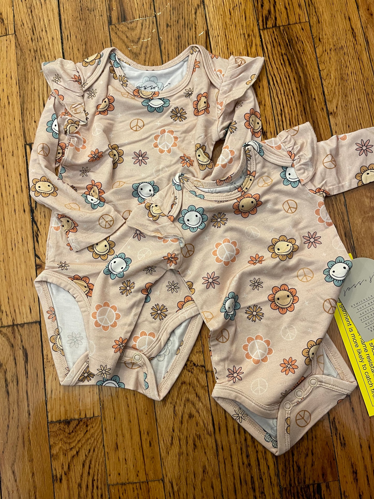 Peace + love ruffle onesie